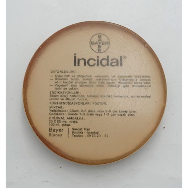 BAYER- İncidal tanıtımlı plastik kâğıt ağırlığı, 10x2,5 cm